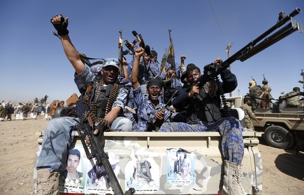 Houthi fighters chant slogans from the back of a vehicle during a January 3rd, 2017, gathering in Sanaa to mobilise fighters to battlefronts. [Mohammed Huwais/AFP]