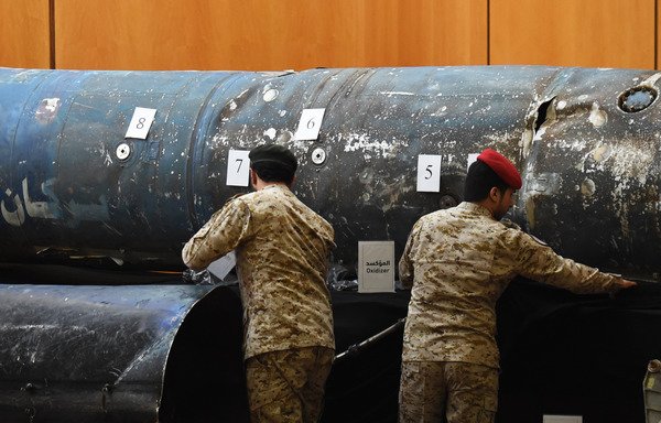 Saudi soldiers reveal the remains of missiles the Arab coalition claims are Iranian during a press conference at the Armed Forces club in Riyadh on March 26th. [Fayez Nureldine/AFP]
