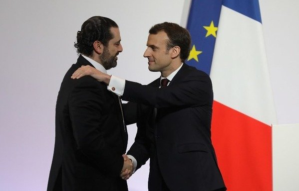 French President Emmanuel Macron shakes hands with Lebanese Prime Minister Saad al-Hariri during the International Cedre Conference on April 6th in Paris. [Ludovic Marin/POOL/AFP]