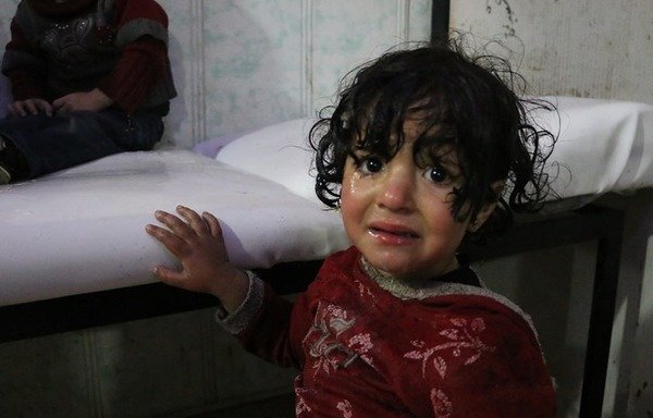 A child in the city of Douma in the opposition enclave of Eastern Ghouta outside Damascus was doused with water after being exposed to what is believed to be toxic gas. [Photo courtesy of Mohammed al-Beik]