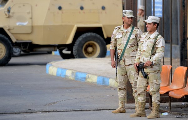 Egyptian army conscripts stand guard outside the Suez Canal University hospital in the eastern port city of Ismailia on November 25th, 2017, where the victims of a bomb and gun assault on the North Sinai Rawda mosque that took place the day before are receiving treatment. [Mohamed al-Shahed/AFP]