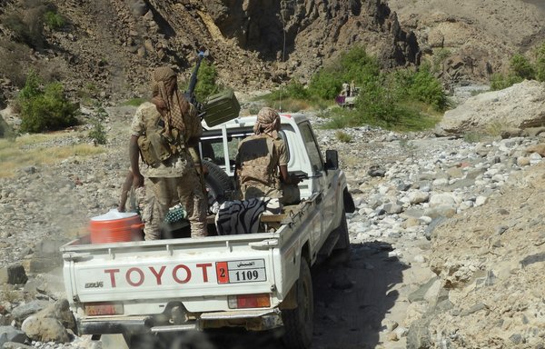 Yemeni fighters loyal to the government of President Abd Rabbu Mansour Hadi ride in a truck with mounted heavy machine gun while closing in on a suspected location of an al-Qaeda in the Arabian Peninsula leader during an offensive in Hadramaut's Masini Valley on February 21st. [Saleh al-Obeidi/AFP]