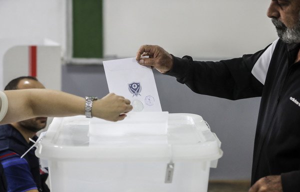 A Lebanese man puts his checked ballot in the box as he casts his vote in the first parliamentary election in nine years, in the coastal city of Byblos on May 6th. [Joseph Eid/AFP]
