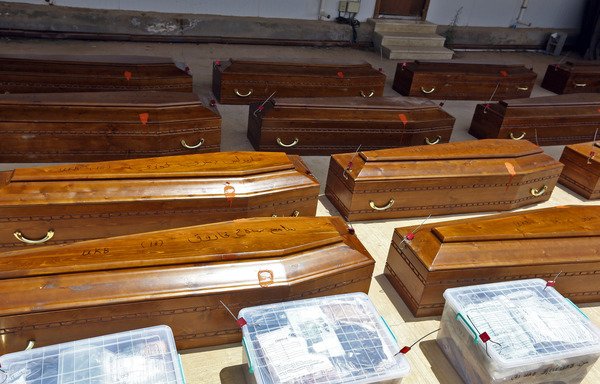 Coffins containing the remains of 20 Egyptian Copts beheaded by ISIS on the beach in Sirte in 2015 are seen at the office of criminal investigations in Misrata prior to being expatriated to Cairo on May 14th. [Mahmud Turkia/AFP]
