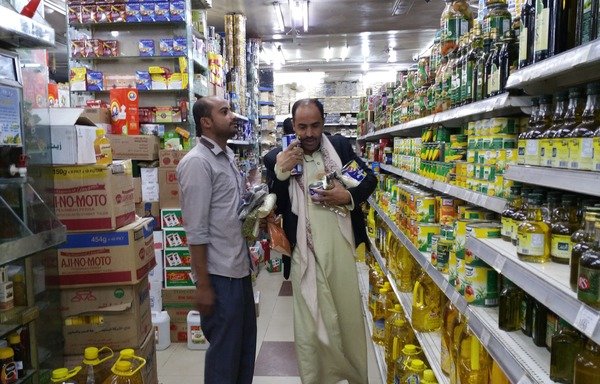 A Yemeni man shops at a store in Sanaa's al-Asbahi district. [Abu Bakr al-Yamani/Al-Mashareq]