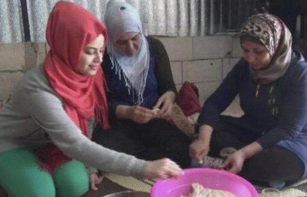 Syrian refugee women prepare pastries for iftar at a camp in Bar Elias, in Lebanon's Bekaa Valley. [Nohad Topalian/Al-Mashareq]