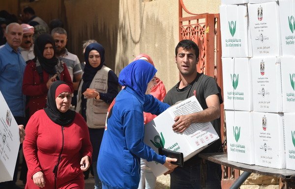 Syrian refugees receive Ramadan food boxes in Lebanon's Baalbek as part of the annual Emirati Iftar Project. [Photo courtesy of the UAE embassy in Lebanon]