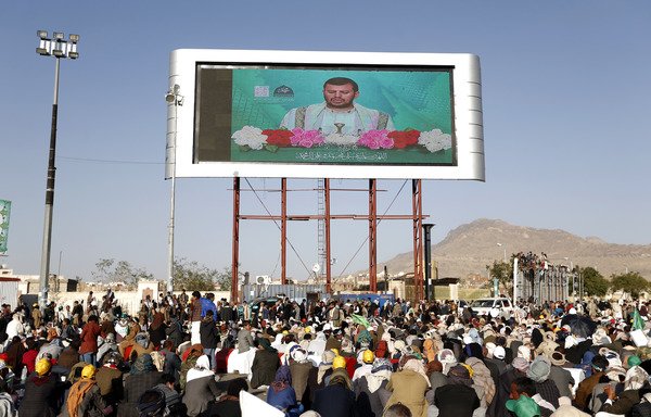 Houthis watch a live speech given by leader Abdul-Malik al-Houthi on a big-screen TV during a November 30th rally in Sanaa. While the Houthis have banned mosque loudspeakers from broadcasting the Taraweeh prayers during Ramadan, critics point to events like this, saying the decree is hypocritical. [Mohammed Huwais/AFP]