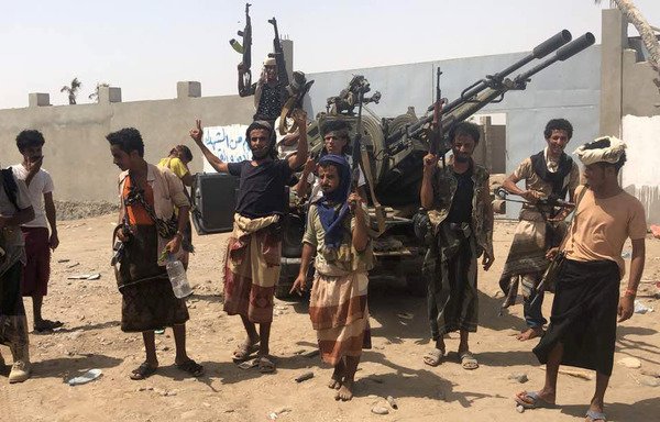 Yemeni pro-government forces backed by the Arab coalition gather during their fight against the Houthi militia in the area of al-Hodeida's airport on June 18th. [Nabil Hassan/AFP]