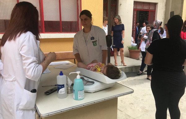 A nurse provides care to a Syrian child at Karagheusian Primary Health Care Centre in Lebanon's Burj Hammoud. [Nohad Topalian/Al-Mashareq]