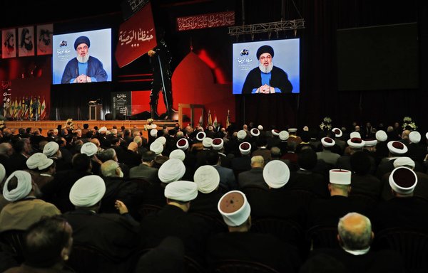 Lebanese Hizbullah chief Hassan Nasrallah delivers a televised speech during a February 16th ceremony in Beirut commemorating the party's killed leaders. [Joseph Eid/AFP]