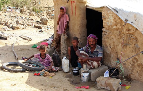 Displaced Yemenis sit outside at a make-shift camp in the Haradh area of the northern Abys district of Yemen's Hajjah province on April 16th. [Essa Ahmed/AFP]