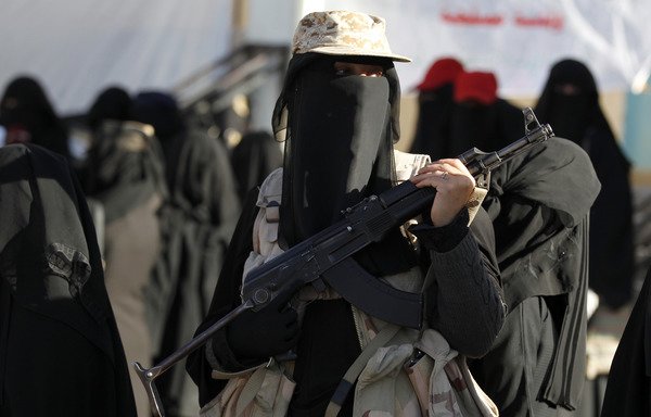 A Yemeni woman loyal to the Houthis holds a rifle as she attends a gathering to show support to the movement in Sanaa on January 14th. [Mohammed Huwais/AFP] 