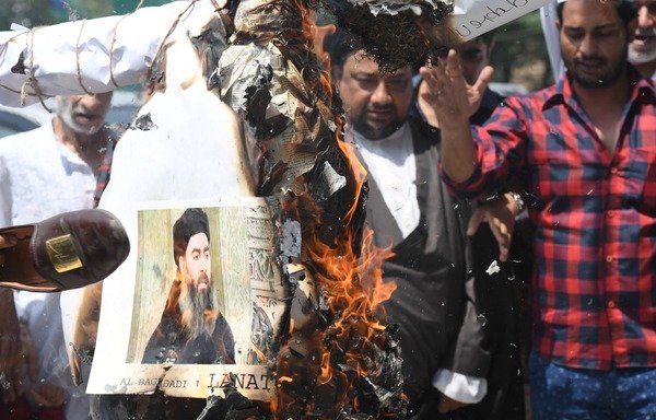 Muslim demonstrators burn an effigy of ISIS leader Abu Bakr al-Baghdadi during a protest in New Delhi on June 9th, 2017. [Prakash Singh/AFP] 
