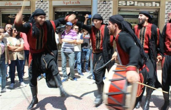 The Layali Baalbek troupe performs the folkloric dabke dance and Baalbeki songs in the city’s market on August 11th. [Tamer Abu Zaid/Al-Mashareq]