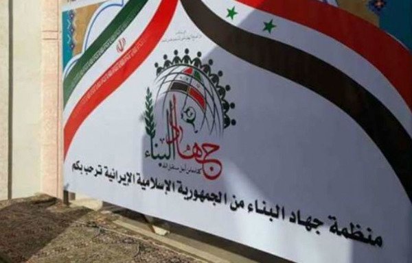 لافتة كتب عليها "مؤسسة جهاد البناء ترحب بك" مرفوعة أمام مستشفى في بلدة البو كمال الحدودية السورية. [حقوق الصورة لجميل العبد]