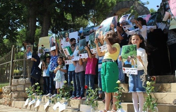 Syrian families take part in a protest to raise awareness about the plight of Syrians who were forcibly disappeared since 2011. [Photo courtesy of Families for Freedom]