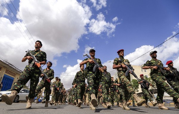 Houthi fighters march in Sanaa on October 16th. The Houthis have been using tactics similar to those employed by Iran's IRGC to extend their control over the population, experts say. [Mohammed Huwais/AFP]