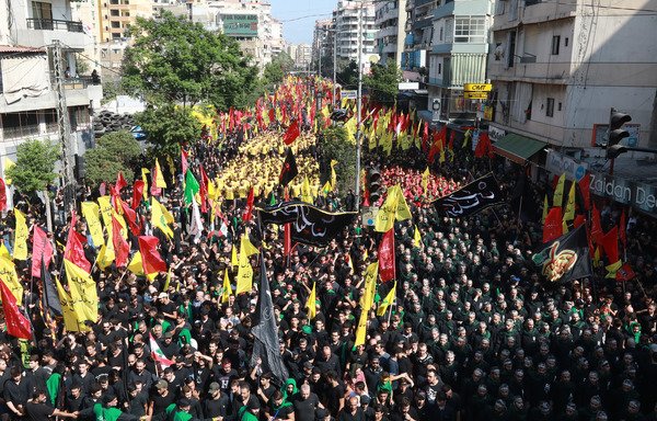 Supporters of Lebanese militia Hizbullah take part in a parade to mark Ashura on September 20th in Beirut. Newly imposed sanctions by the US on Hizbullah will help curb the Iran-backed militia's malign activities in the region by cutting off its sources of funding. [Anwar Amro/AFP]