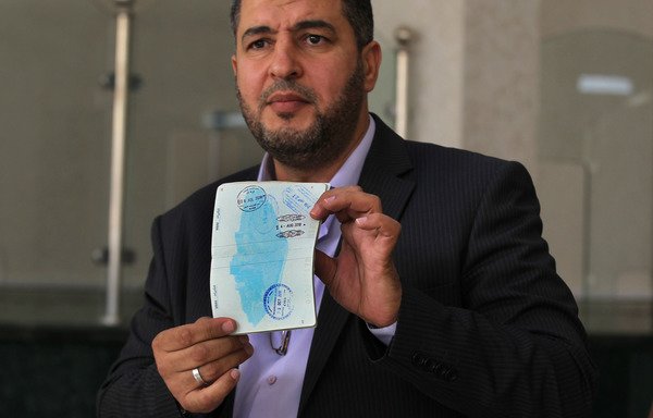 A Syrian man shows off his passport at the Nassib-Jaber border crossing between Jordan and Syria after it reopened for cross-border trade and transport on October 15th. [Mohammad Abu Ghoush/Al-Mashareq]