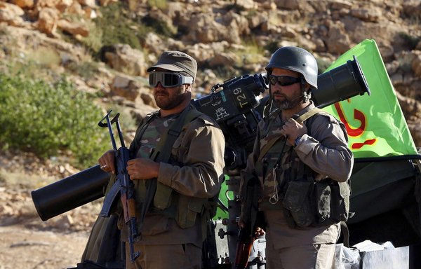 New financial pressures on Iran will force Hizbullah, whose fighters are pictured here, to curtail its activities outside Lebanon, experts say. [Photo circulated on social media]