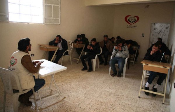 Mohammad Ramadan, the instructor at the association for the blind, leads a classroom on November 10th, 2018, in the opposition-controlled town of Anjara, in the western Aleppo countryside. [Aaref Watad/AFP]