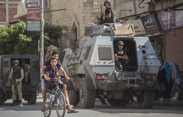 A picture taken on July 26th shows Egyptian policemen guarding a street in the North Sinai provincial capital of al-Arish. [Khaled Desouki/AFP]