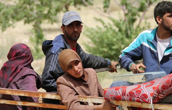 لاجئون سوريون على متن شاحنة في مدينة عرسال اللبنانية الحدودية، وهم متجهون نحو منطقة القلمون السورية في 12 تموز/يوليو 2017. وفي حين أن مستقبل اللاجئين السوريين سيكون في النهاية في وطنهم الأم، إلا أنه يُرجح أن تتطلب عملية العودة وقتا طويلا بالنسبة للبعض. [صحافي مستقل/وكالة الصحافة الفرنسية]