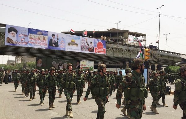 Fighters from the pro-Iran Harakat al-Nujaba militia take part in a parade in Baghdad. [Photo from Harakat al-Nujaba's Facebook page] 