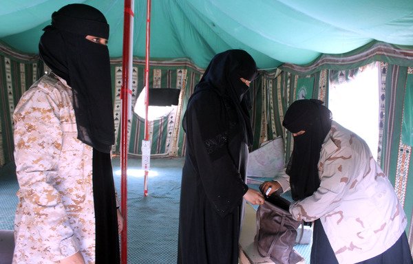 Yemeni female guards search a woman's bag in the former al-Qaeda in the Arabian Peninsula (AQAP) bastion of al-Mukalla in Yemen's coastal southern Hadramaut province, on November 30th. [Saleh al-Obeidi/AFP]