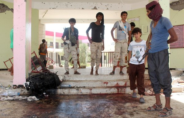 Yemenis look at a blood-stained floor at an army recruitment centre in Aden following a suicide car bombing claimed by ISIS in this file photo from August 29th. The attacker drove an explosives-laden vehicle into a gathering of army recruits at a school, killing at least 60. [Saleh al-Obeidi/AFP]