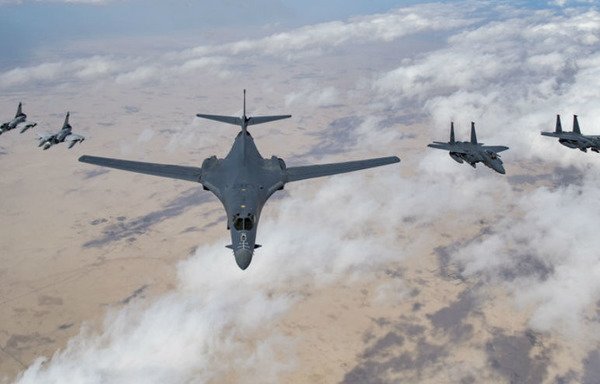 Two Qatari Mirage 2000s (L), a US Air Force B-1B Lancer bomber (C) and F-15E Strike Eagles fly in formation during a Joint Air Defense Exercise on February 19th. [File] 