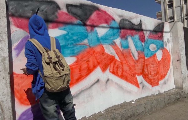 Young Yemeni artists lined up across a wall in Sanaa on March 14th painting murals that reflect their fears and hopes in a country crippled by war. [AFP]