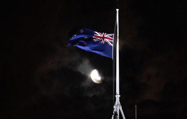 The New Zealand national flag is flown at half-mast on a parliament building in Wellington on March 15th, after an attack on two mosques in Christchurch left at least 49 dead. [Marty Melville/AFP]