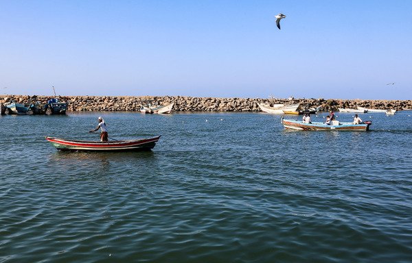 Yemeni fishermen sit in their boats in the Red Sea waters off the embattled port city of al-Hodeidah on January 1st. Iran has been training the Houthis on how to target ships passing through the Red Sea, the Yemeni army spokesman said. [AFP/Stringer]
