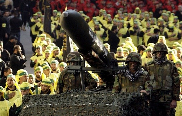 Members of Lebanon's Hizbullah march beside an Iranian missile at a military parade in the southern suburb of Beirut. [Photo circulated on social media]