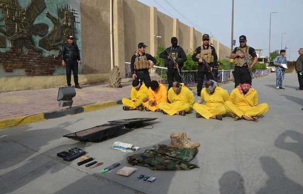 Iraqi forces in Basra province stand with individuals who were arrested on drug dealing charges in this file photo from December 5th, 2016. [Photo courtesy of Basra Police Department]