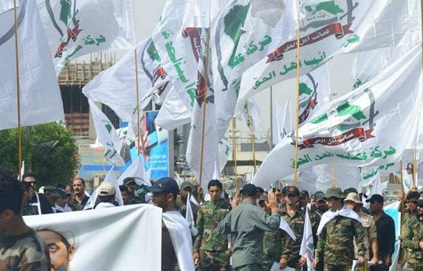 Members of the Iran-backed Asaib Ahl al-Haq are pictured during a parade in Baghdad in June 2018. [Photo to the militia's website]