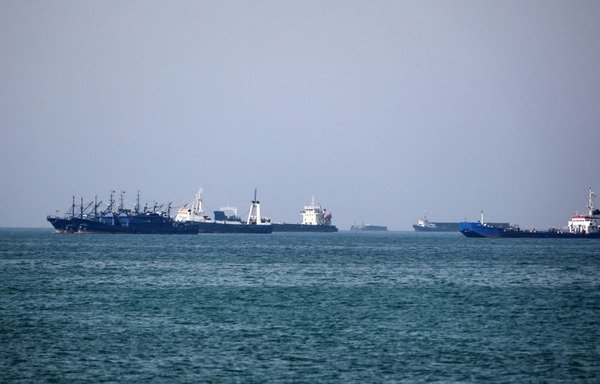 Cargo ships sail in the Gulf off the Iranian port city of Bandar Abbas, which has a strategic position on the Strait of Hormuz, on April 29th. [Atta Kenare/AFP]