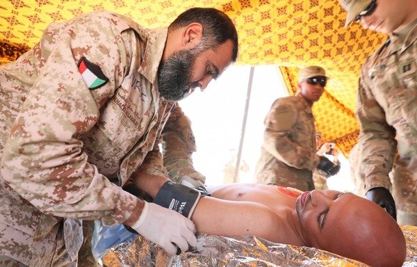 Kuwaiti ground troops and US soldiers treat a 'wounded' person during the Pacemaker III joint training exercise at Camp Buehring in Udairi, Kuwait. [Photo courtesy of US Army]