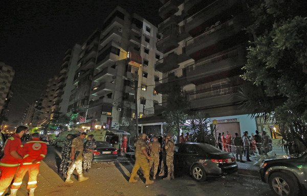 Lebanese security forces inspect the building where a militant attacked a security forces patrol and blew himself up when confronted in the northern port city of Tripoli on June 3rd, on the eve of Eid el-Fitr. [Ibrahim Chalhoub/AFP]
