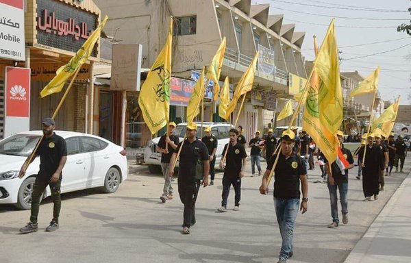 Members of the Iran-backed Iraqi militia Harakat al-Nujaba take part in a parade in al-Diwaniya province in southern Iraq. [Photo circulated on social media]