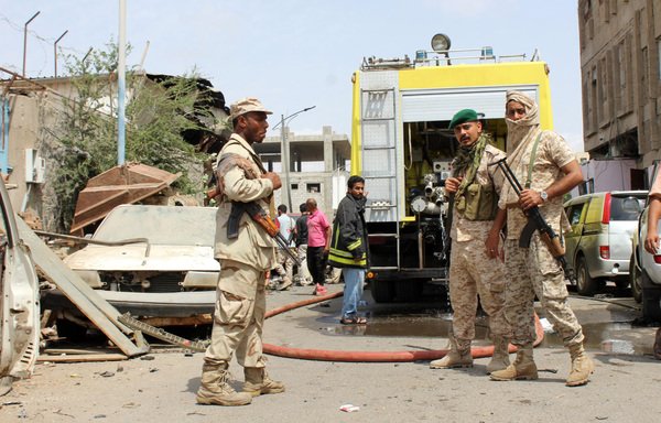 A picture taken on March 13th, 2018 in the southern Yemeni city of Aden shows Yemeni soldiers at the scene of an explosion from a suicide bombing claimed by ISIS which hit UAE-trained Yemeni troops. [Saleh al-Obeidi/AFP]