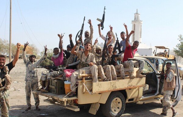 Forces loyal to the Yemeni government and supported by the Arab coalition flash their arms at a road on the entrance to Abyan province as they take part in an operation to drive al-Qaeda fighters out of the southern provincial capital, on April 23rd, 2016. [Saleh al-Obeidi/AFP]