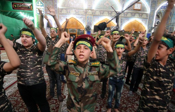 Iraqi youth participate in a rally organised by the Iran-backed Harakat al-Nujaba in Najaf in 2016. The militia has been bribing poor people to attend its events after attendance has dwindled in recent months. [Photo circulated online] 
