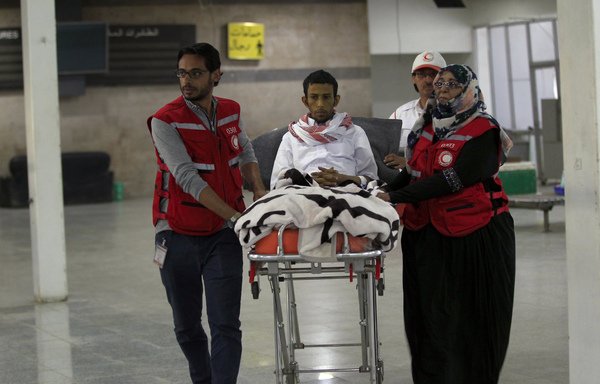 Members of the International Committee of the Red Cross transport Saudi prisoner Musa al-Awaji on a stretcher to board a plane at Sanaa airport following his release by the Houthis on January 29th under a deal agreed between the government and the Houthis at UN-brokered peace talks in Sweden. [Mohammed Huwais/AFP]
