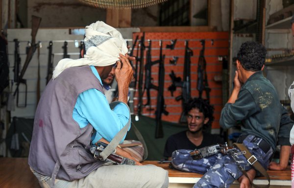 Armed men shop in Yemen's Taez, on July 13th. Before the war, the city's old market was crowded with people and full of handcrafts and artisanal goods. More than four years after the Houthis began their siege on the city, bullets and guns have taken over the market. [Ahmad al-Basha/AFP]