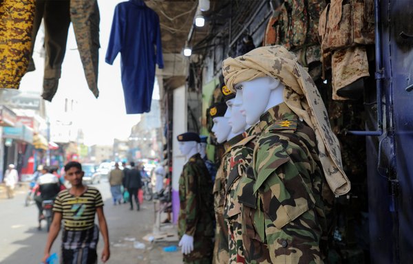 Military fatigues are displayed at a shop in Taez on July 13th. [Ahmad al-Basha/AFP] 