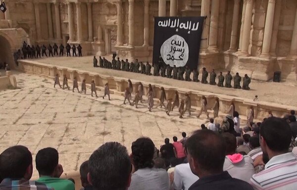 ISIS teen executioners prepare to shoot 25 Syrian regime soldiers in front of crowds in Palmyra, Syria, in 2015. Such crimes will be detailed in trials sought by the international community. [File]