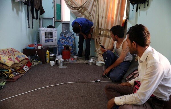 Iranian labourers, seeking jobs in Iraq's Kurdish region to make up for the deteriorating economic situation at home, reside in a cheap hostel in Erbil, on July 1st. [Safin Hamed/AFP]